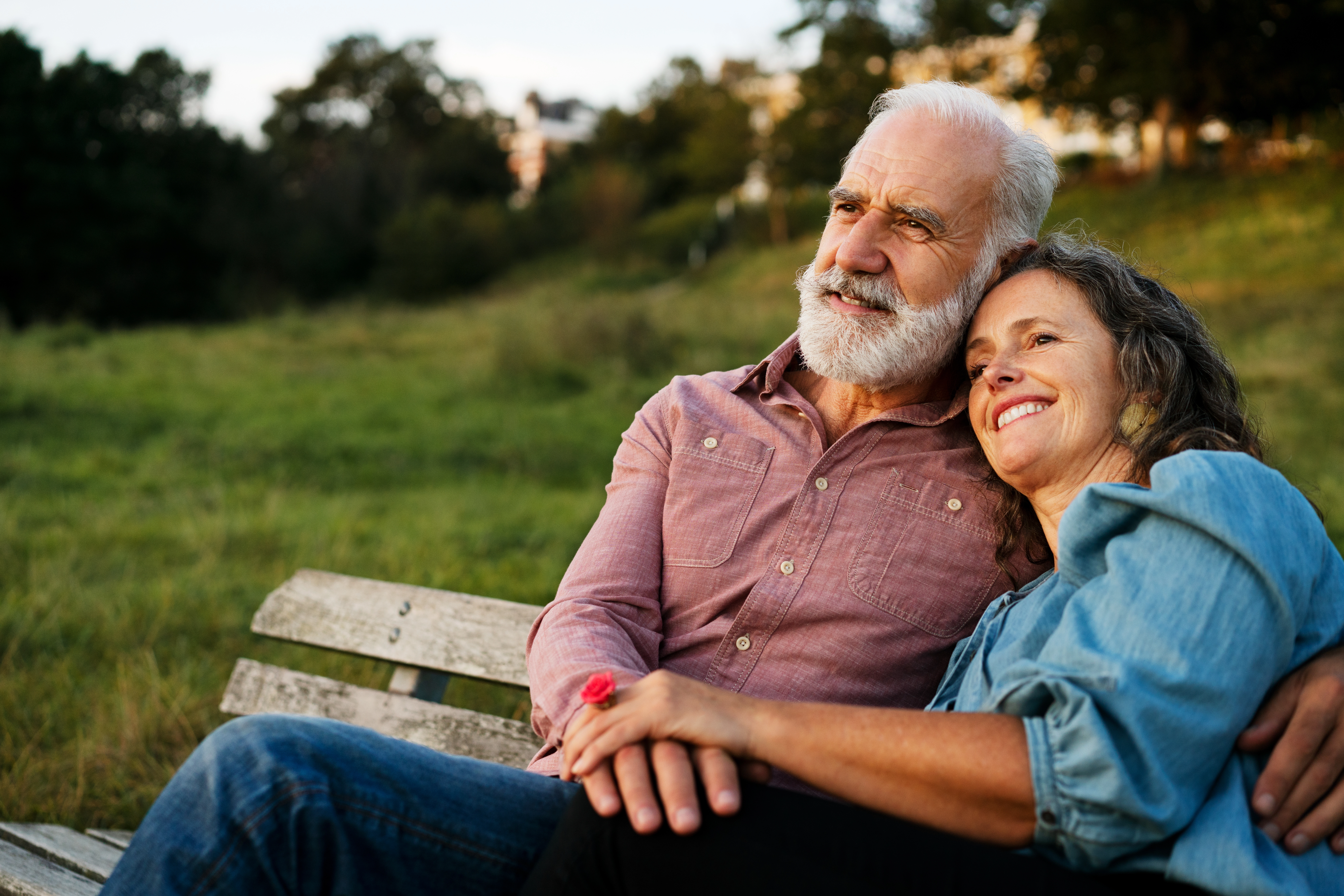 Senior couple sitting on a park bench.