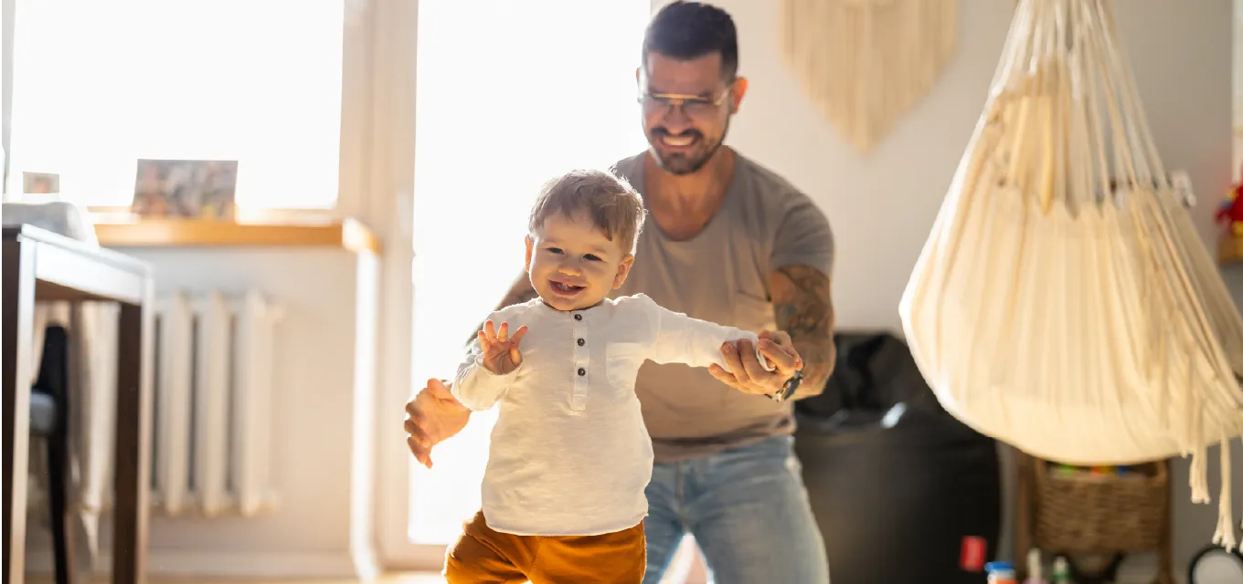 small child walking in front of parent.
