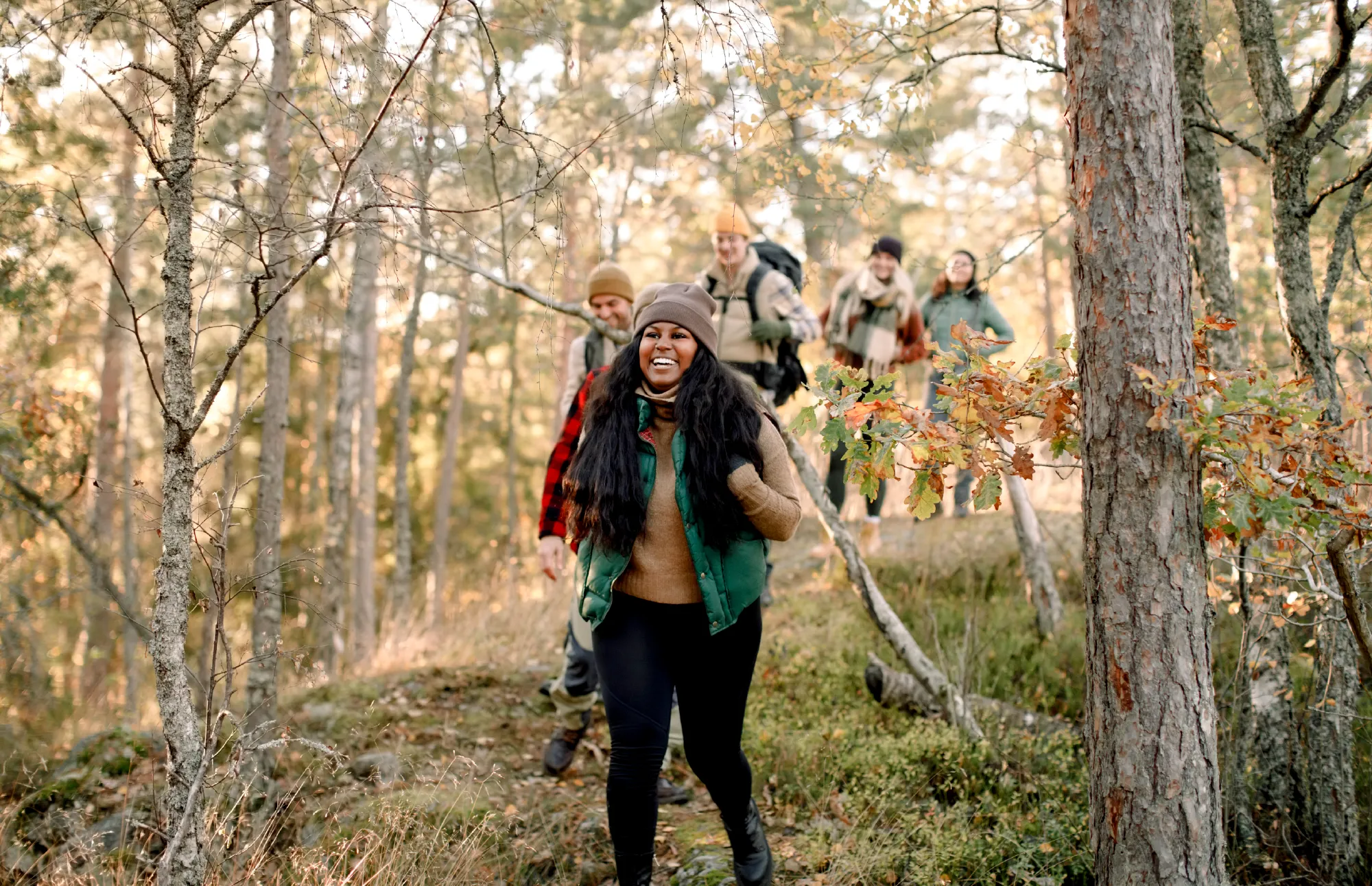 group of friends walking in the woods.