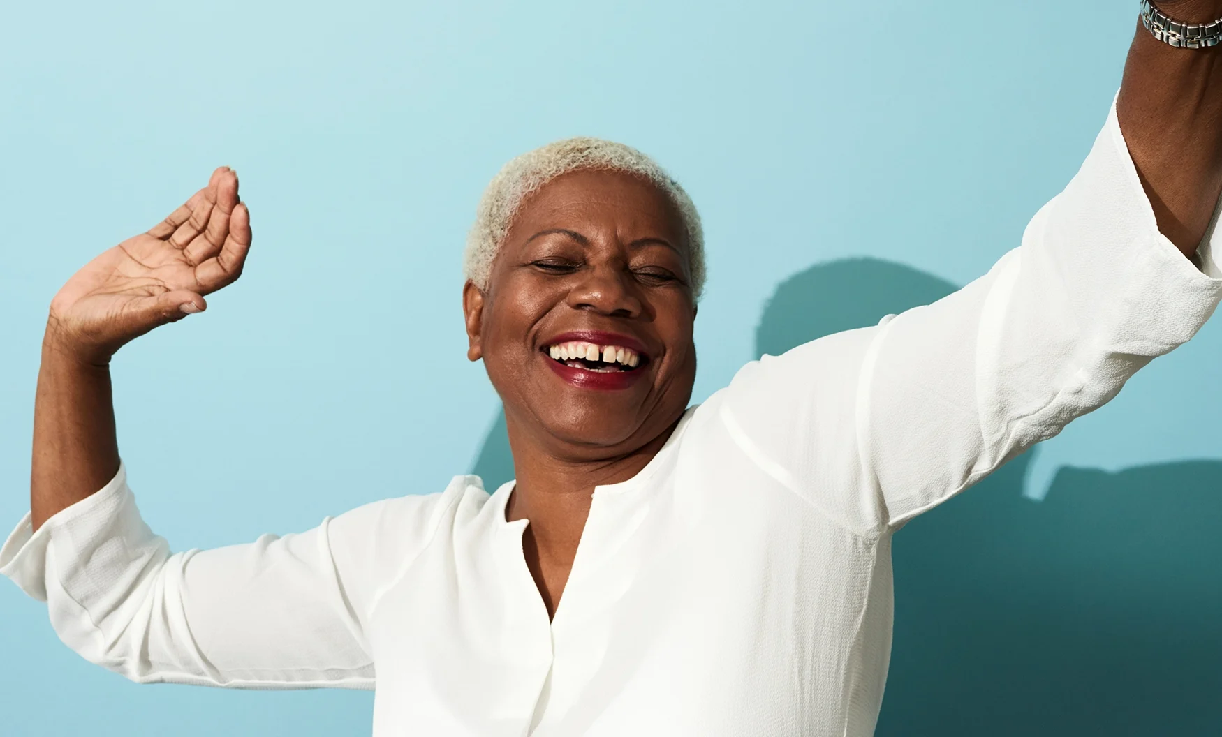 African-American woman smiles while dancing