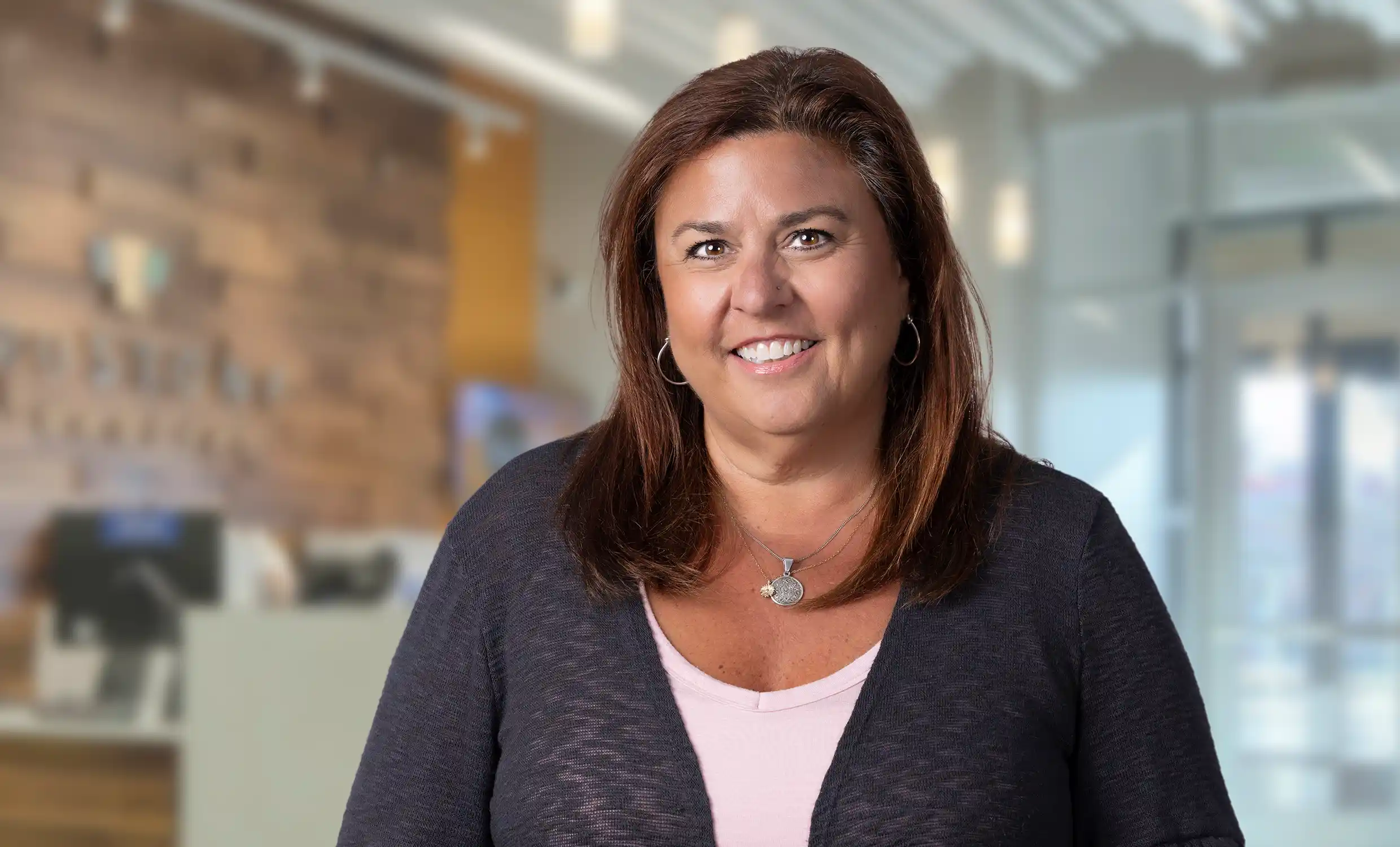 Gina smiling in an office setting