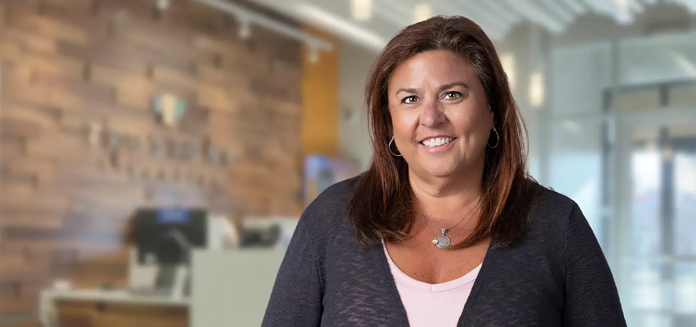 Gina smiling in an office setting