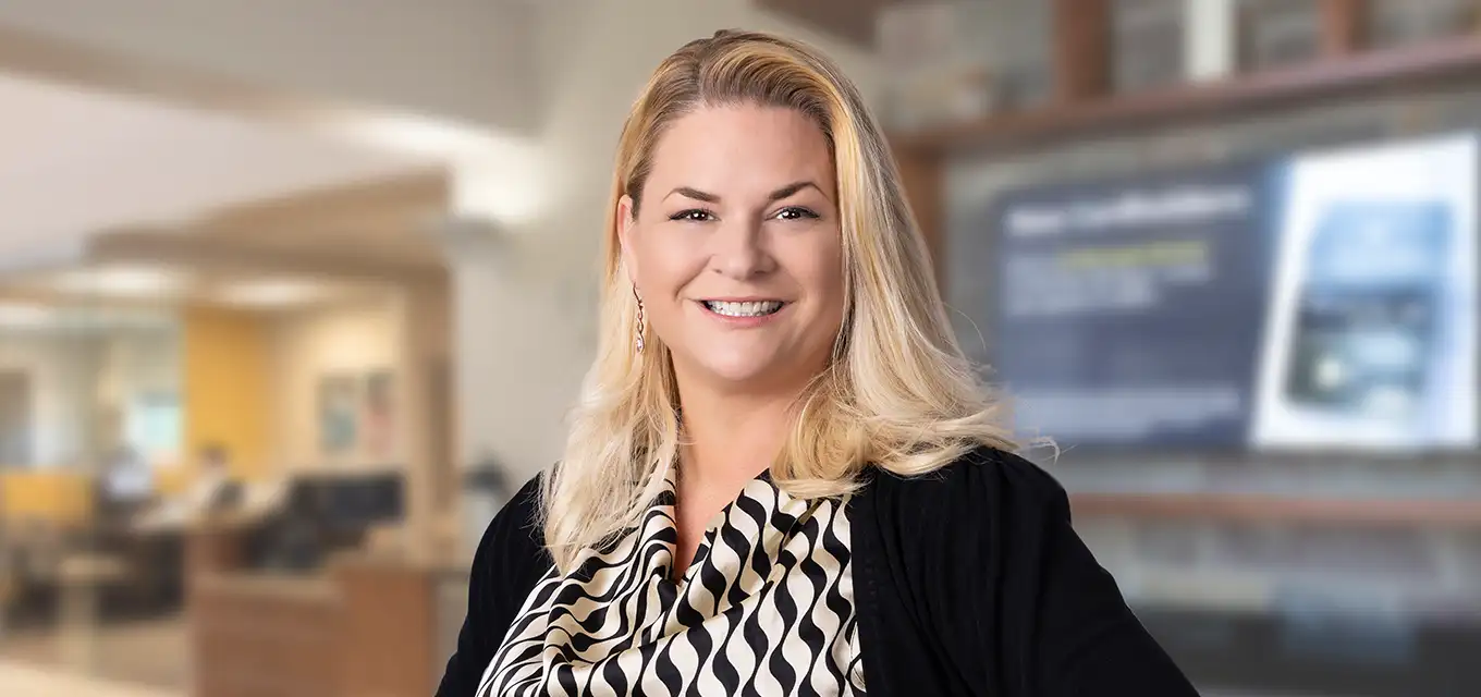 Whitney smiling in an office setting