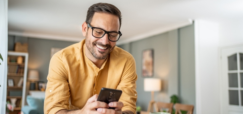 Man smiling at his phone