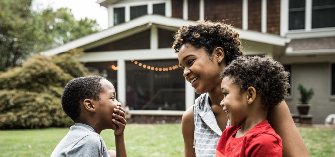 Mother and her two children sitting outside sharing a laugh