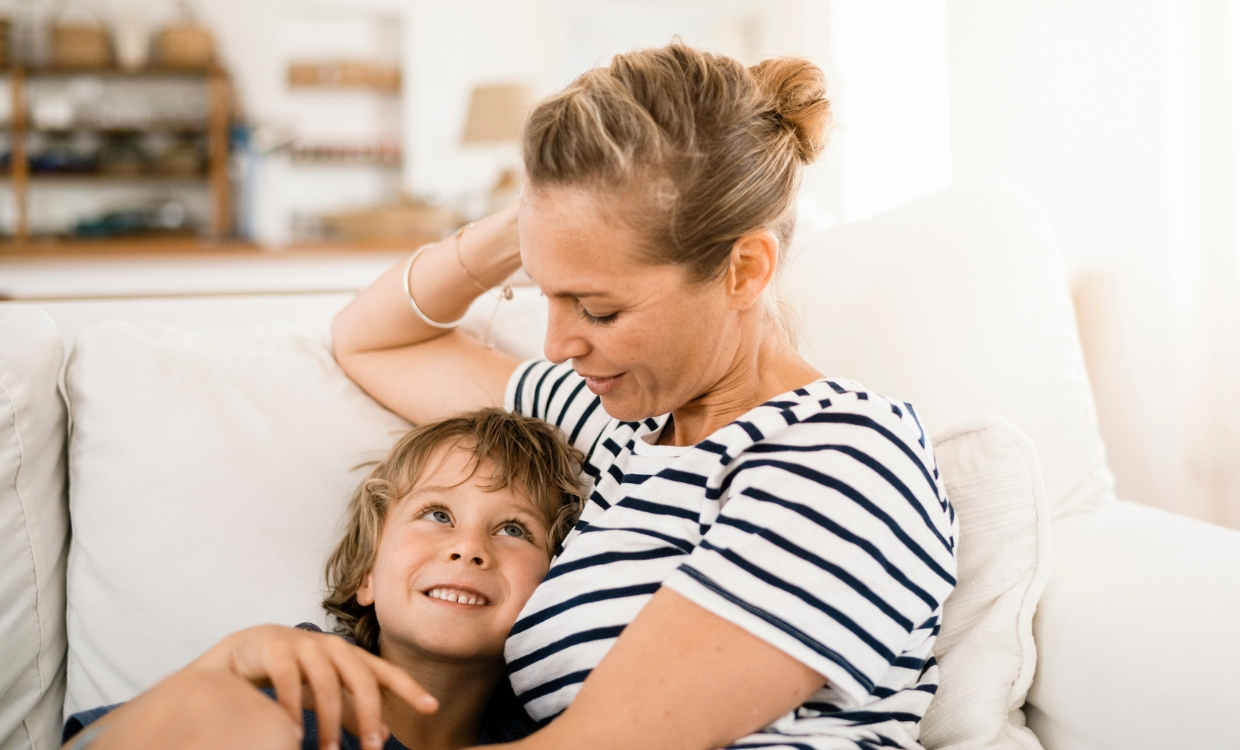 Mother and son sitting on the couch together