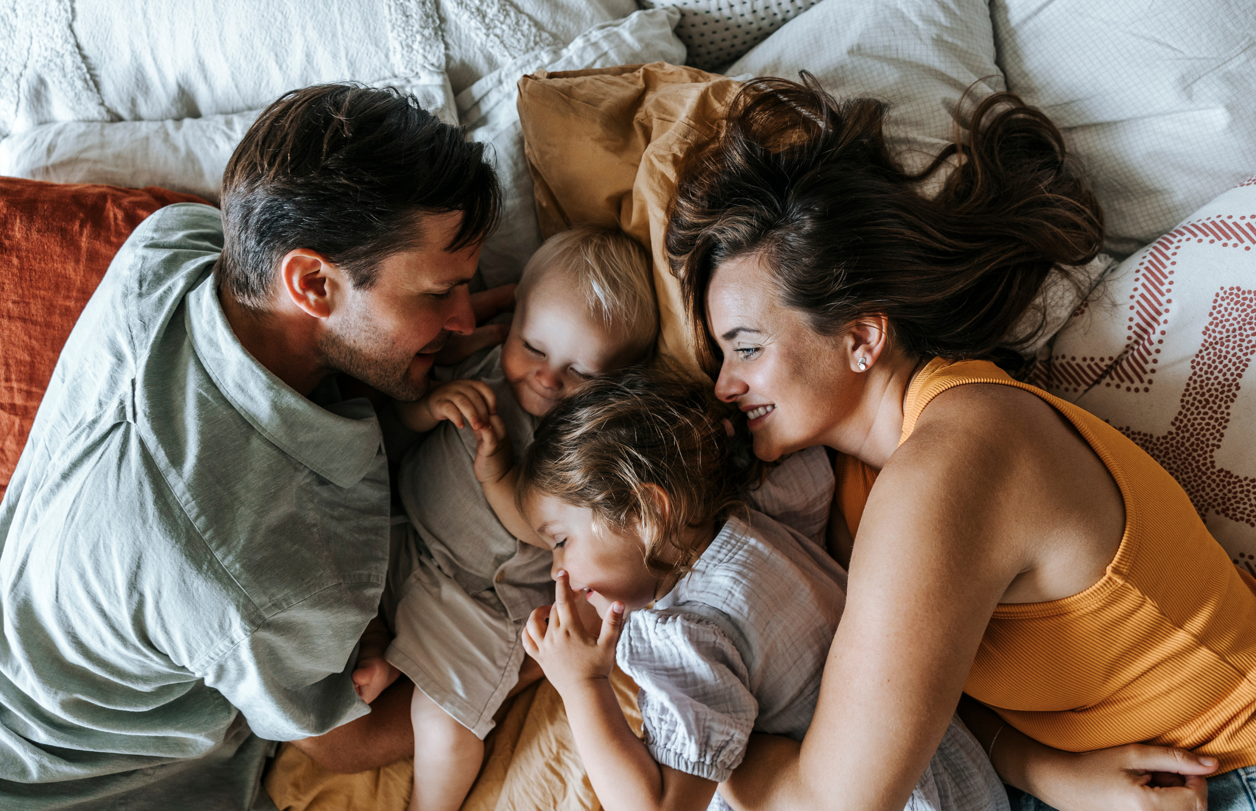 Family laying in bed
